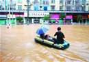 广西融水苗族自治县居民在积水街道上划橡皮艇行进